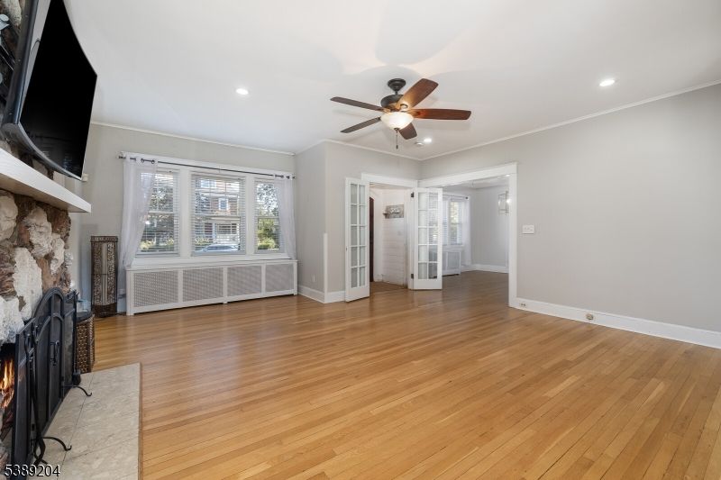 Empty room, Fireplace, Interior, Recessed Lighting, Stone Walls, Wood Texture Flooring
