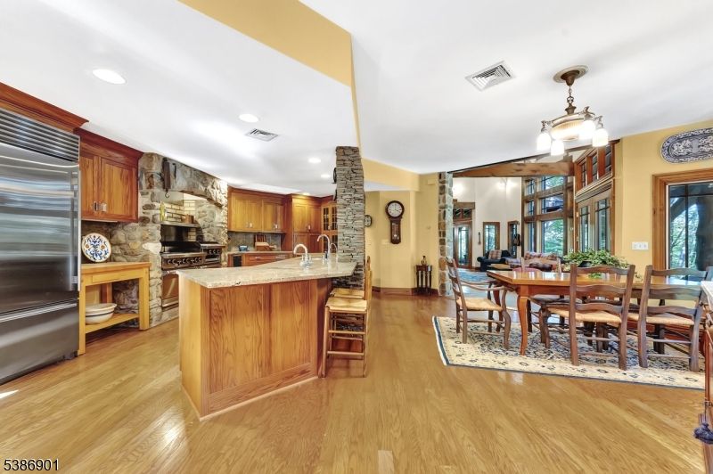 Dining room, Fireplace, Interior, Kitchen, Pendant Lights, Recessed Lighting, Stainless Steel Appliances, Wood Texture Flooring