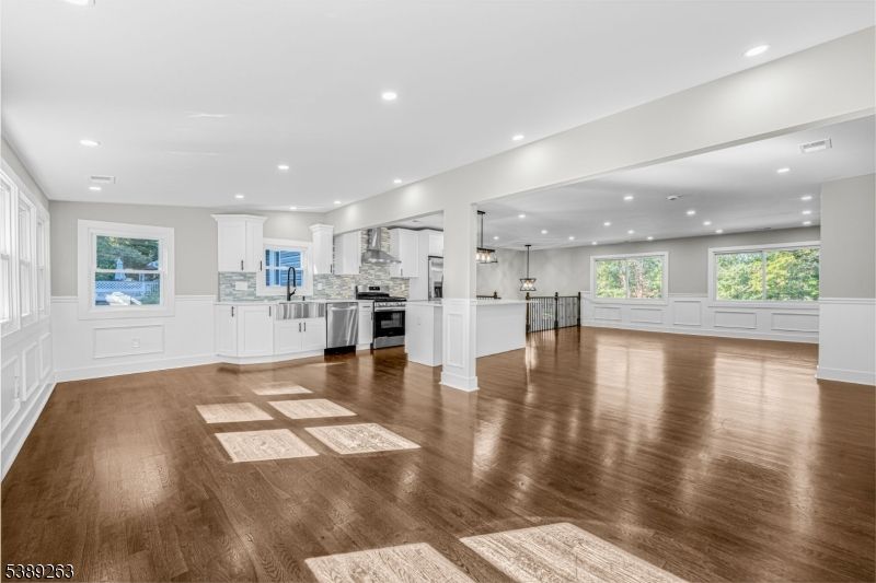 Empty room, Interior, Kitchen, Pendant Lights, Recessed Lighting, Stainless Steel Appliances, Wood Texture Flooring
