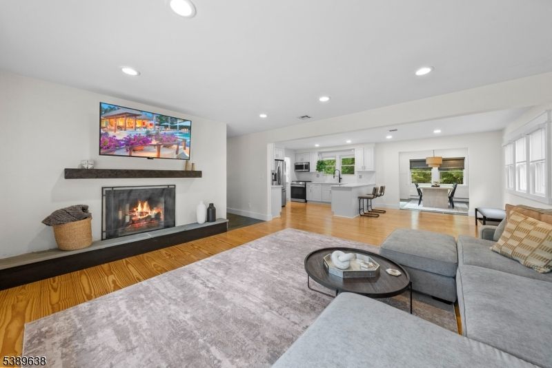 Dining room, Fireplace, Interior, Kitchen, Living room, Recessed Lighting, Stainless Steel Appliances, Wood Texture Flooring