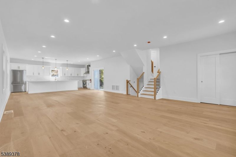 Empty room, Interior, Kitchen, Pendant Lights, Recessed Lighting, Stainless Steel Appliances, Wood Texture Flooring