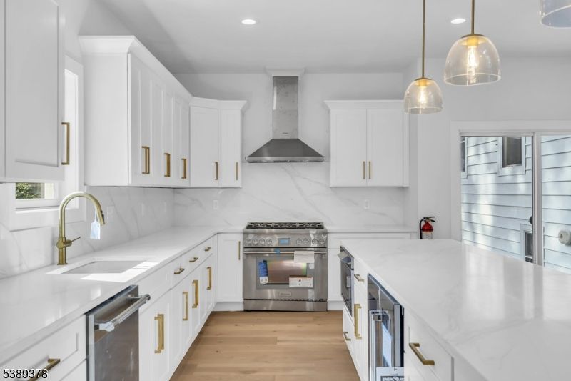 Interior, Kitchen, Marble Walls, Pendant Lights, Recessed Lighting, Stainless Steel Appliances, Wood Texture Flooring