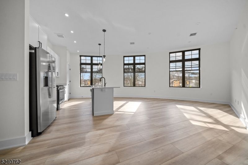 Empty room, Interior, Kitchen, Pendant Lights, Recessed Lighting, Stainless Steel Appliances, Wood Texture Flooring