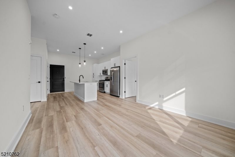 Empty room, Interior, Kitchen, Pendant Lights, Recessed Lighting, Stainless Steel Appliances, Wood Texture Flooring