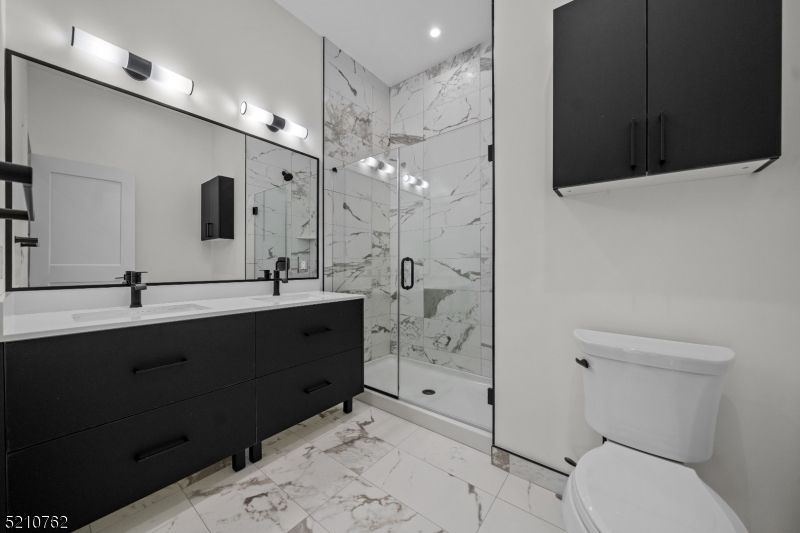Bathroom, Dual Sink Vanities, Glass Shower, Interior, Marble, Marble Walls, Recessed Lighting