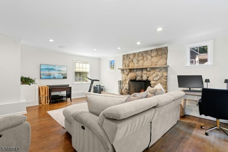 Fireplace, Fitness Equipment, Home Office, Interior, Living room, Recessed Lighting, Stone Walls, Wood Texture Flooring