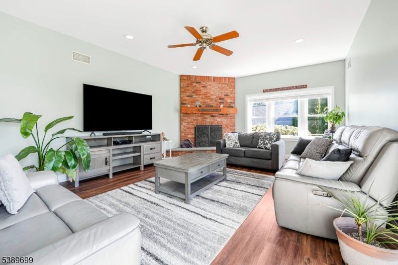 Fireplace, Interior, Living room, Recessed Lighting, Stone Walls, Wood Texture Flooring