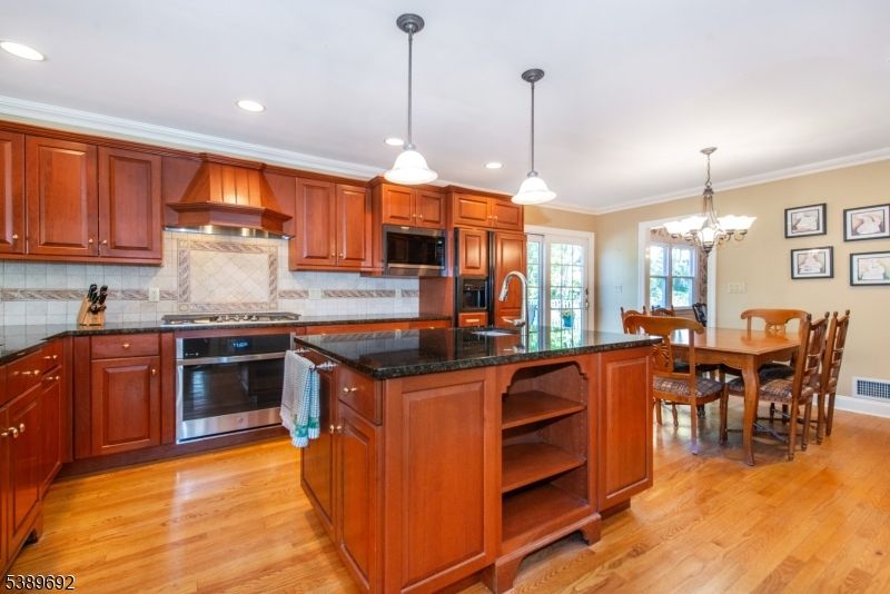 Chandelier, Dining room, Interior, Kitchen, Pendant Lights, Recessed Lighting, Stainless Steel Appliances, Wood Texture Flooring