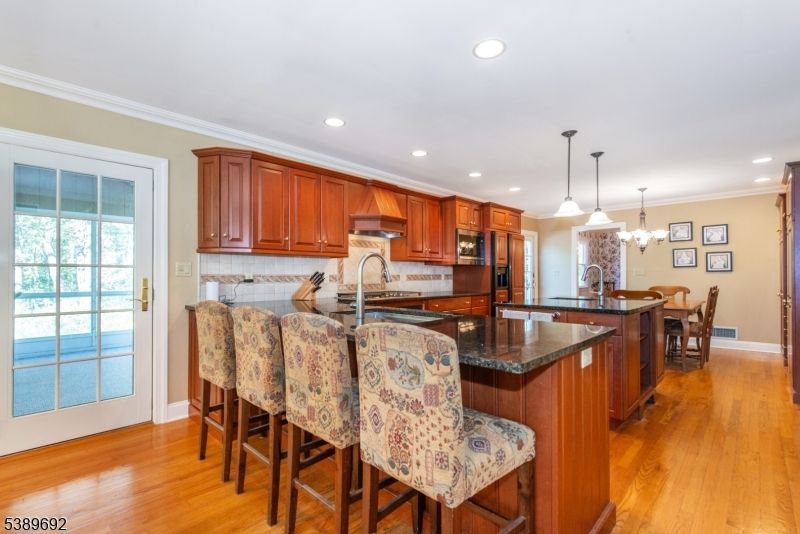 Chandelier, Dining room, Interior, Kitchen, Pendant Lights, Recessed Lighting, Water, Wood Texture Flooring