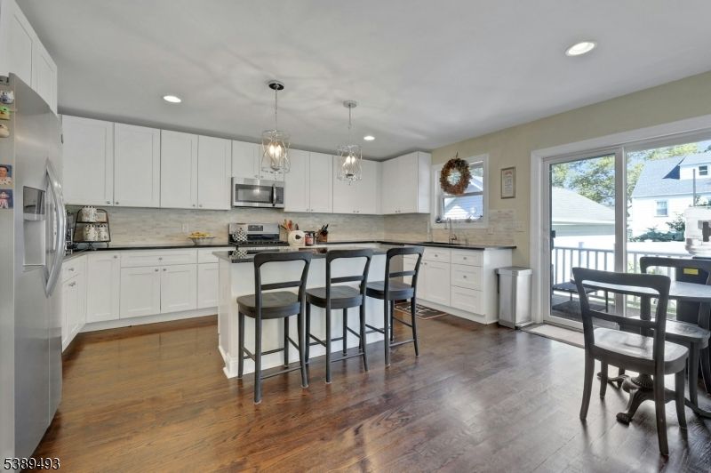 Dining room, Interior, Kitchen, Pendant Lights, Recessed Lighting, Stainless Steel Appliances, Wood Texture Flooring