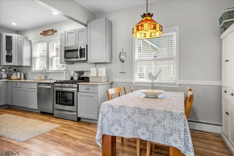 Dining room, Interior, Kitchen, Pendant Lights, Recessed Lighting, Stainless Steel Appliances, Wood Texture Flooring