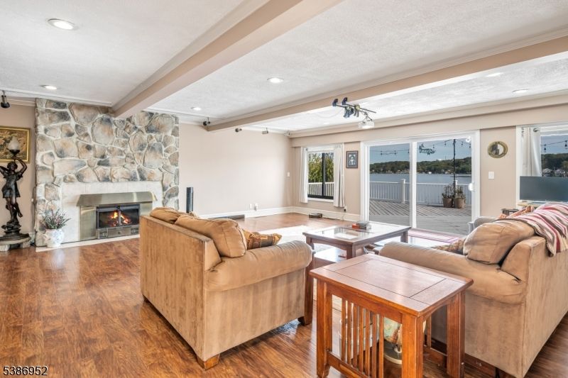 Fireplace, Interior, Living room, Recessed Lighting, Stone Walls, Wood Texture Flooring