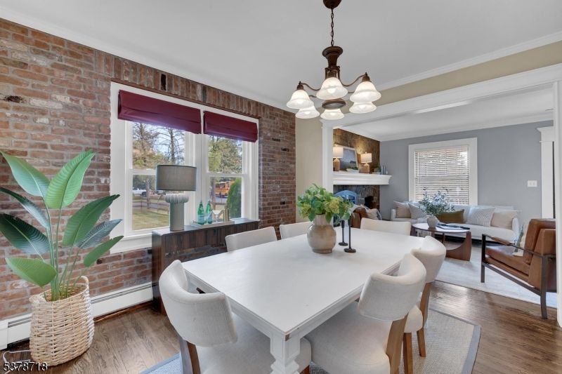 Chandelier, Dining room, Fireplace, Interior, Living room, Stone Walls, Wood Texture Flooring