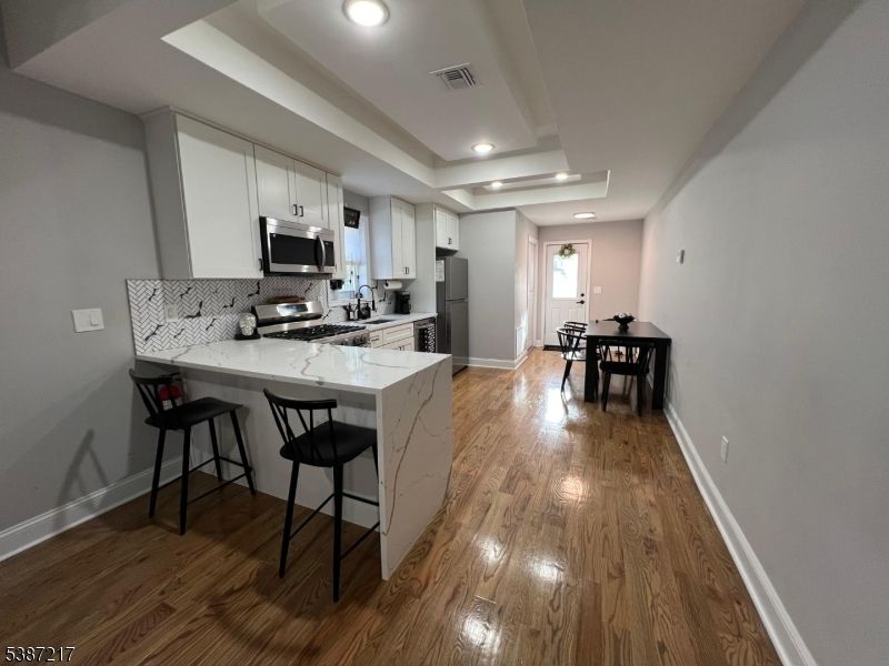 Dining room, Interior, Kitchen, Recessed Lighting, Stainless Steel Appliances, Wood Texture Flooring