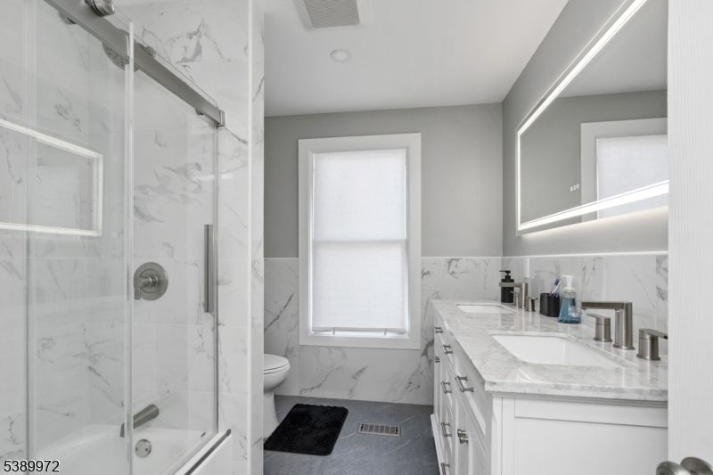 Bathroom, Dual Sink Vanities, Glass Shower, Interior, Marble Walls, Recessed Lighting