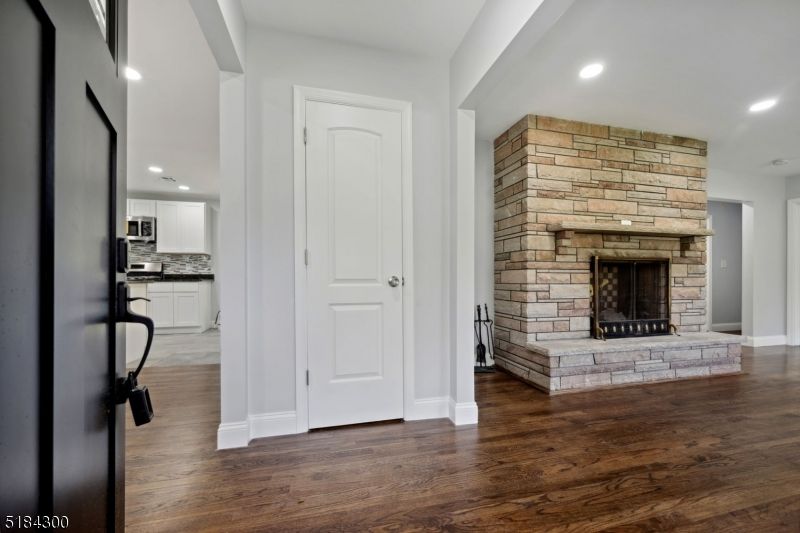 Empty room, Fireplace, Interior, Kitchen, Recessed Lighting, Stone Walls, Wood Texture Flooring