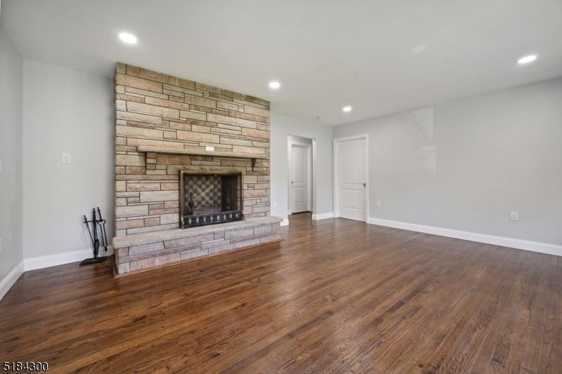 Empty room, Fireplace, Interior, Recessed Lighting, Stone Walls, Wood Texture Flooring