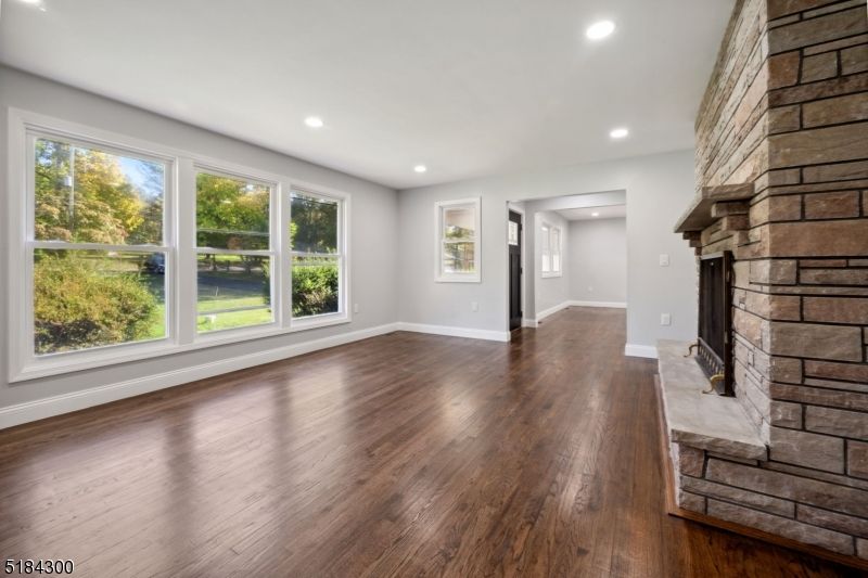 Empty room, Fireplace, Interior, Recessed Lighting, Stone Walls, Wood Texture Flooring