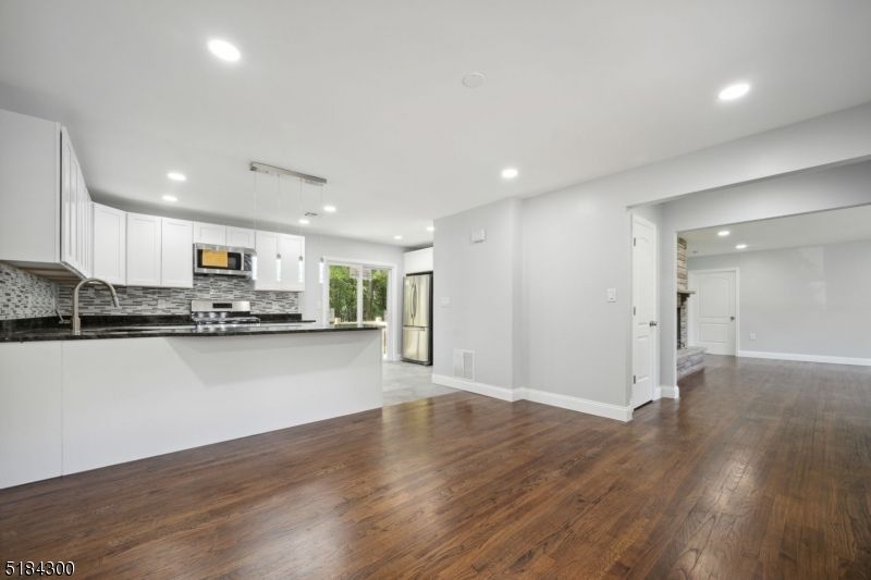 Empty room, Interior, Kitchen, Pendant Lights, Recessed Lighting, Stainless Steel Appliances, Wood Texture Flooring