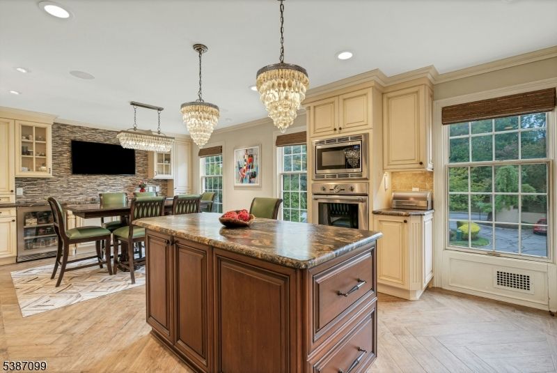 Chandelier, Dining room, Interior, Kitchen, Recessed Lighting, Stainless Steel Appliances, Stone Walls, Wood Texture Flooring