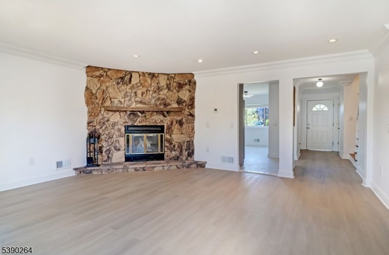 Empty room, Fireplace, Interior, Recessed Lighting, Stone Walls, Wood Texture Flooring