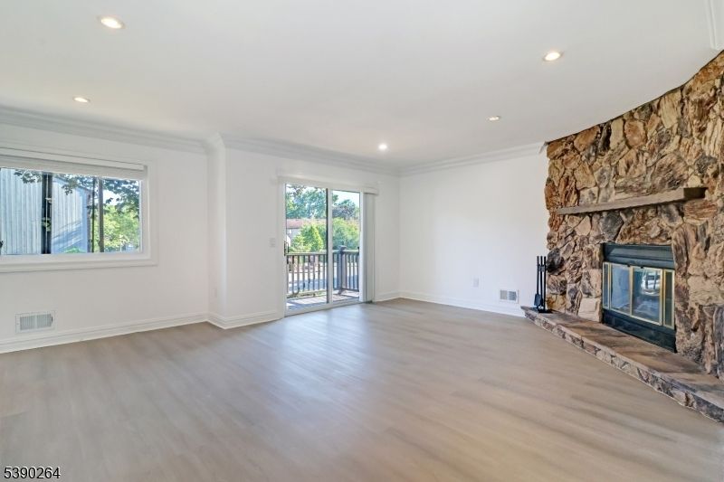 Empty room, Fireplace, Interior, Recessed Lighting, Stone Walls, Wood Texture Flooring