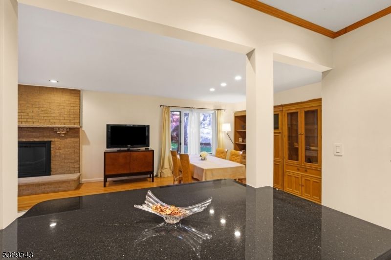 Dining room, Fireplace, Interior, Recessed Lighting, Stone Walls, Wood Texture Flooring