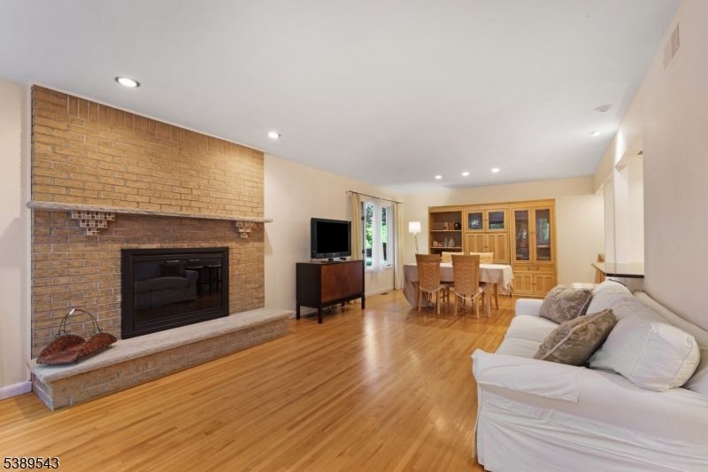Dining room, Fireplace, Interior, Living room, Recessed Lighting, Stone Walls, Wood Texture Flooring