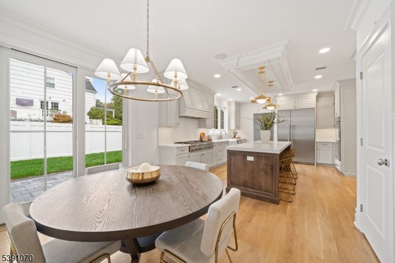 Chandelier, Dining room, Interior, Kitchen, Pendant Lights, Recessed Lighting, Stainless Steel Appliances, Wood Texture Flooring