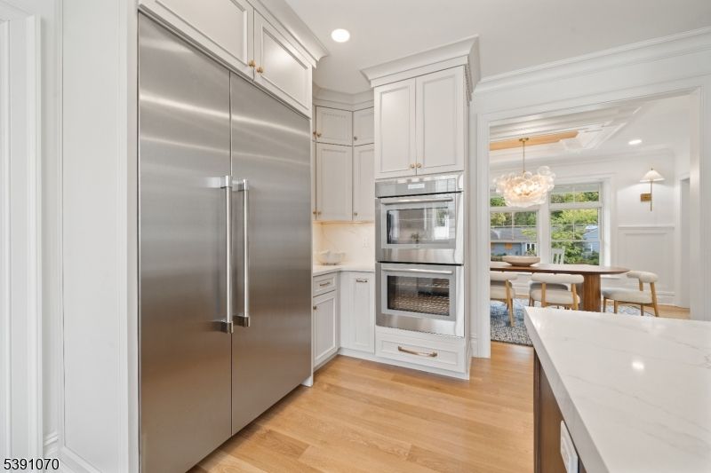 Chandelier, Dining room, Interior, Kitchen, Recessed Lighting, Stainless Steel Appliances, Wood Texture Flooring