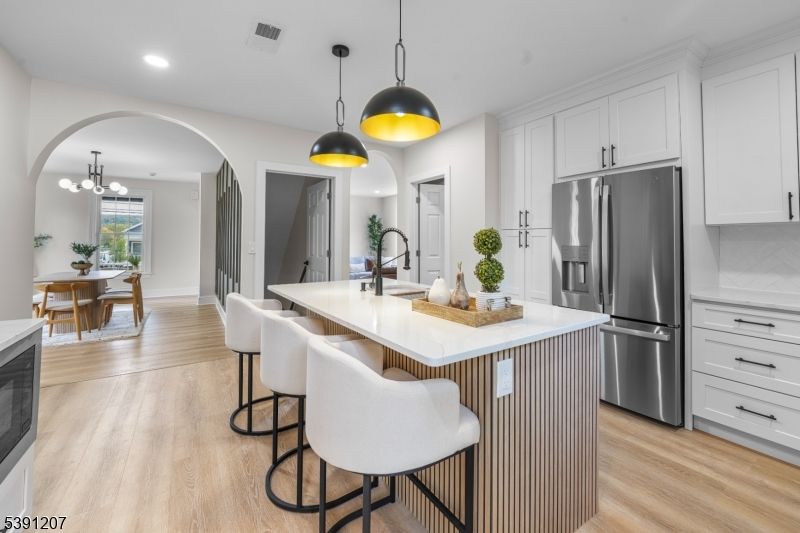 Chandelier, Dining room, Interior, Kitchen, Pendant Lights, Recessed Lighting, Stainless Steel Appliances, Wood Texture Flooring
