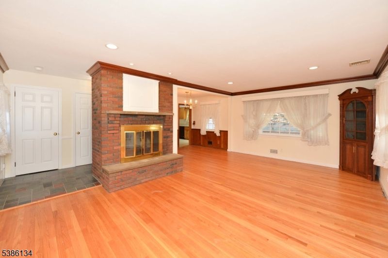 Chandelier, Empty room, Fireplace, Interior, Recessed Lighting, Wood Texture Flooring