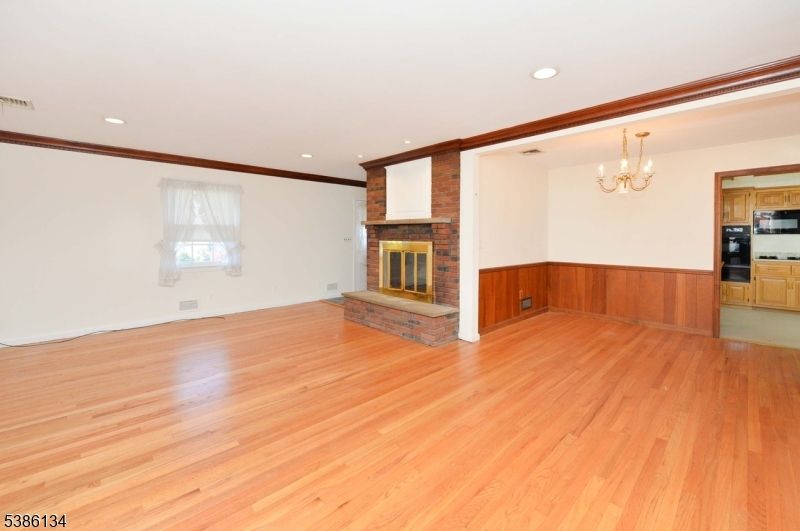 Chandelier, Empty room, Fireplace, Interior, Kitchen, Recessed Lighting, Wood Texture Flooring