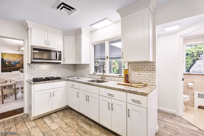 Dining room, Interior, Kitchen, Recessed Lighting, Stainless Steel Appliances, Wood Texture Flooring