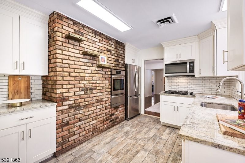 Interior, Kitchen, Recessed Lighting, Stainless Steel Appliances, Stone Walls, Wood Texture Flooring