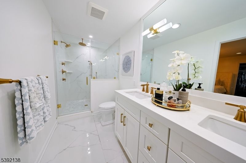 Bathroom, Dual Sink Vanities, Glass Shower, Interior, Marble, Marble Walls, Recessed Lighting