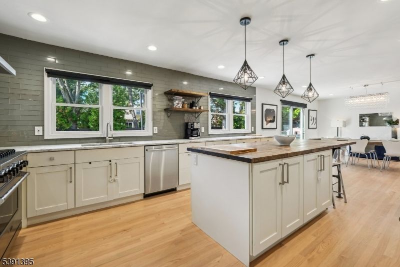 Dining room, Interior, Kitchen, Pendant Lights, Recessed Lighting, Stainless Steel Appliances, Wood Texture Flooring