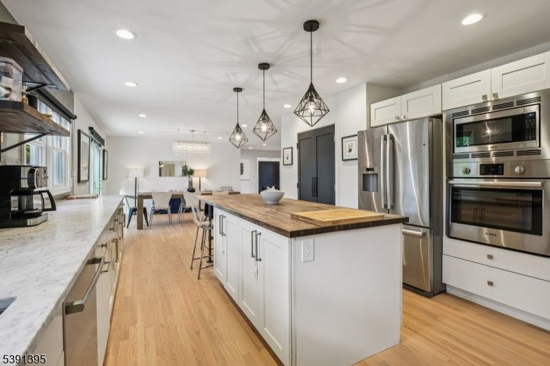 Dining room, Interior, Kitchen, Pendant Lights, Recessed Lighting, Stainless Steel Appliances, Wood Texture Flooring