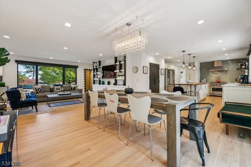 Chandelier, Dining room, Interior, Kitchen, Living room, Pendant Lights, Recessed Lighting, Stainless Steel Appliances, Wood Texture Flooring