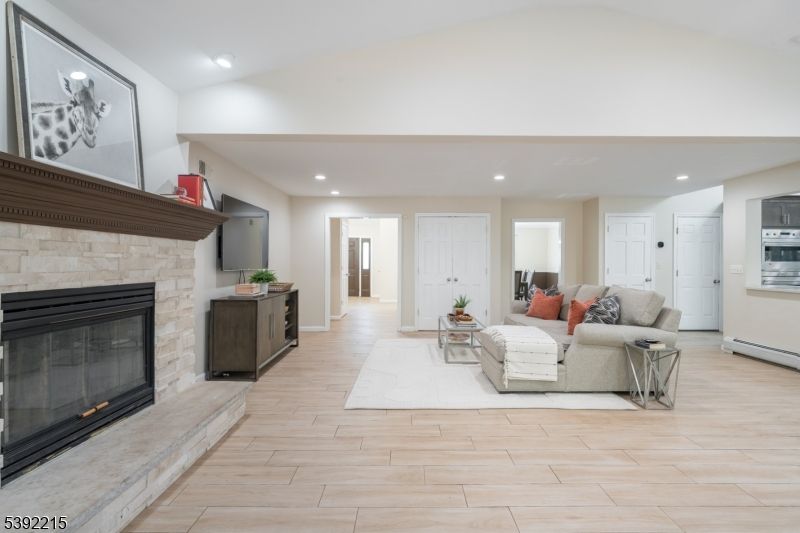Fireplace, Interior, Living room, Recessed Lighting, Stone Walls, Wood Texture Flooring