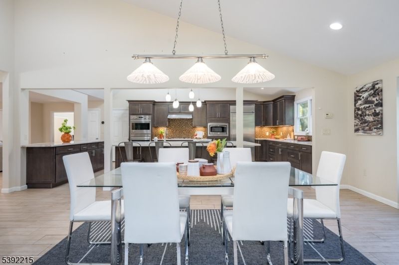 Dining room, Interior, Kitchen, Pendant Lights, Recessed Lighting, Stainless Steel Appliances, Wood Texture Flooring