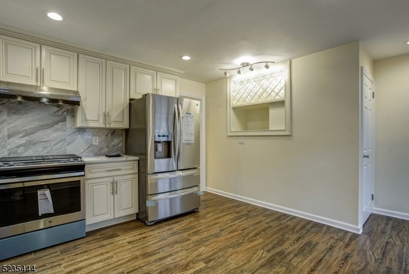 Interior, Kitchen, Marble Walls, Recessed Lighting, Stainless Steel Appliances, Wood Texture Flooring