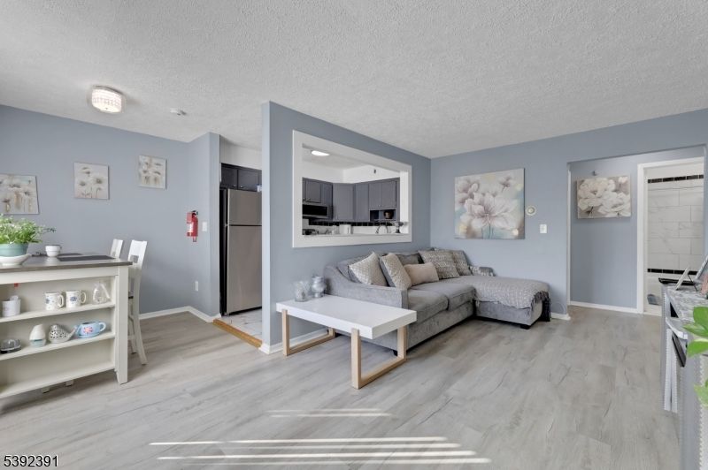 Dining room, Interior, Kitchen, Living room, Recessed Lighting, Stainless Steel Appliances, Wood Texture Flooring