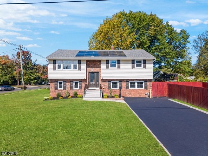 Exterior, Facade, Brick Facade, Solar Panels, Raised Ranch