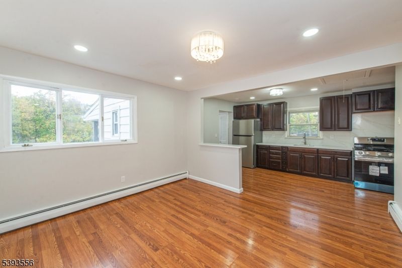 Chandelier, Empty room, Interior, Kitchen, Recessed Lighting, Stainless Steel Appliances, Wood Texture Flooring