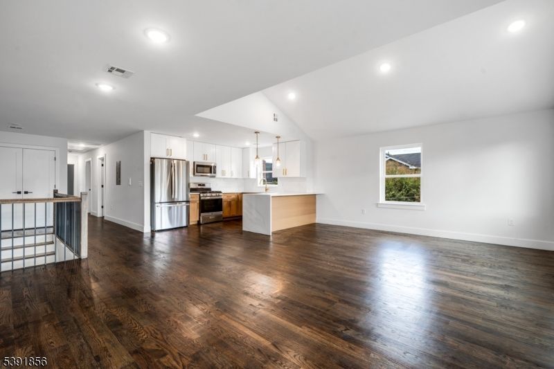 Empty room, Interior, Kitchen, Recessed Lighting, Stainless Steel Appliances, Wood Texture Flooring