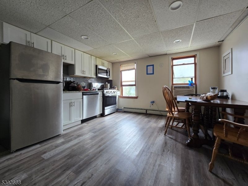 Dining room, Interior, Kitchen, Recessed Lighting, Stainless Steel Appliances, Wood Texture Flooring