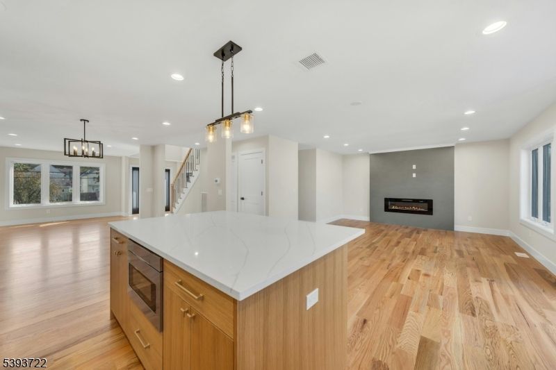 Empty room, Fireplace, Interior, Kitchen, Pendant Lights, Recessed Lighting, Wood Texture Flooring