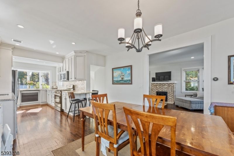 Chandelier, Dining room, Fireplace, Interior, Kitchen, Recessed Lighting, Wood Texture Flooring