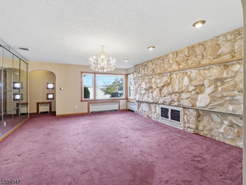 Chandelier, Empty room, Fireplace, Interior, Recessed Lighting, Stone Walls